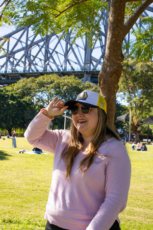 Woman in a park with a bridge in the background